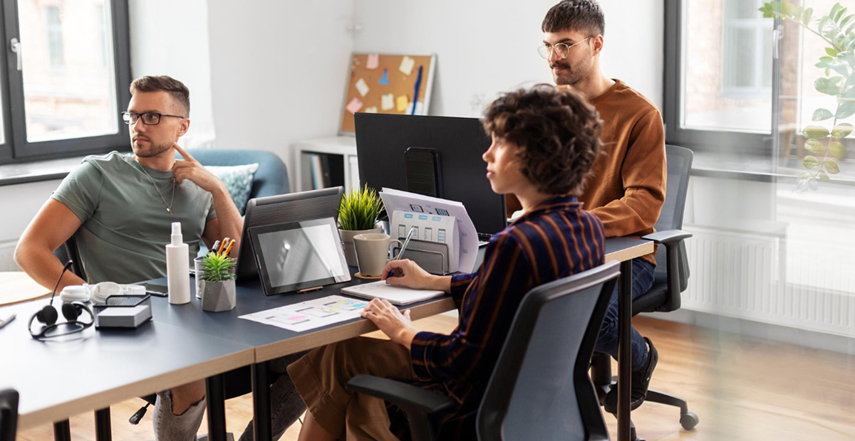 Creative team working through layout options on a studio desk